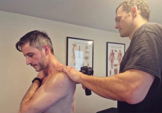 This is me using the massage gun to help me release tension of my patients
shoulder.